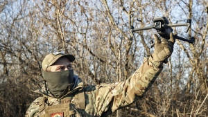 A Ukrainian serviceman flies a drone during an operation against Russian positions at an undisclosed location in the Donetsk region, Ukraine, Sunday, Dec. 4, 2022. (AP Photo/Roman Chop)