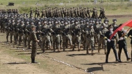 FILE - In this photo released by the Russian Defense Ministry Press Service, Chinese troops line up (march) during the Vostok 2022 military exercise at a firing range in Russia's Far East, on Aug. 31, 2022. A Japanese government-commissioned panel said in a report to Prime Minister Fumio Kishida, that drastic defense buildup including possession of pre-emptive strike capability is “indispensable” amid growing threats in the region, calling for the public’s understanding to bear the financial burden for the defense of their country. (Vadim Savitsky/Russian Defense Ministry Press Service via AP, File)