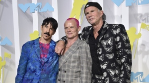 FILE - Anthony Kiedis, from left, Flea and Chad Smith, of Red Hot Chili Peppers, appear at the MTV Video Music Awards on Aug. 28, 2022, in Newark, N.J. Live Nation said Monday the band will perform at a set of stadium shows and festivals across North America and Europe beginning March 29. (Photo by Evan Agostini/Invision/AP, File)