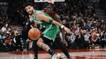 Boston Celtics Jayson Tatum, left, and Toronto Raptors Pascal Siakam eye a loose ball during first half NBA basketball action in Toronto, Monday, Dec. 5, 2022. Tatum had 31 points and 12 rebounds to lift the league-leading Boston Celtics to a 115-110 victory over the Toronto Raptors on Monday. THE CANADIAN PRESS/Chris Young