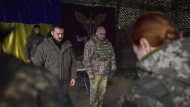In this photo provided by the Ukrainian Presidential Press Office, Ukrainian President Volodymyr Zelenskyy, centre left, stands along servicemen during a minute of silence in honor of soldiers killed during fighting with Russian troops as he visits the Sloviansk, Donbas region, Ukraine, Tuesday, Dec. 6, 2022. (Ukrainian Presidential Press Office via AP)