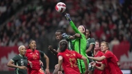 Canada goalkeeper Stephanie Labbe, centre right, punches the ball away from Nigeria's Christy Ucheibe, centre left, during the first half of a women's friendly soccer match, in Vancouver, on Friday, April 8, 2022. A new professional women’s soccer league is coming to Canada. THE CANADIAN PRESS/Darryl Dyck