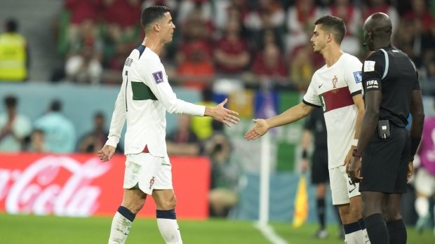 Portugal's Cristiano Ronaldo, left, leaves the pitch to be substituted by Portugal's Andre Silva, right, during the World Cup group H soccer match between South Korea and Portugal, at the Education City Stadium in Al Rayyan, Qatar on Friday, Dec. 2, 2022. (AP Photo/Francisco Seco)