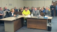 In this image taken from El Paso County District Court video, Anderson Lee Aldrich, 22, center, sits during a court appearance in Colorado Springs, Colo., Tuesday, Dec. Nov. 6, 2022. Aldrich, the suspect accused of entering a Colorado gay nightclub clad in body armor and opening fire with an AR-15-style rifle, killing five people and wounding 17 others, was charged by prosecutors Tuesday with 305 criminal counts including hate crimes and murder. (El Paso County District Court via AP)
