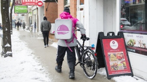 A Foodora courier picks up an order for delivery from a restaurant in Toronto, Thursday, Feb. 27, 2020. From reselling used items or dog walking to taking shifts driving for delivery services and acting as a brand ambassador, there are plenty of ways to earn some extra cash. THE CANADIAN PRESS/Nathan Denette