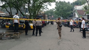 Officers man a road block guard on a street leading to the police station where an explosion went off in Bandung, West Java, Indonesia, Wednesday, Dec. 7, 2022. An unidentified attacker blew himself up outside a police station in Indonesia's main island of Java on Wednesday in a latest of suicide attacks in the world's most populous Muslim nation, police said. (AP Photo/Ahmad Fauzan)
