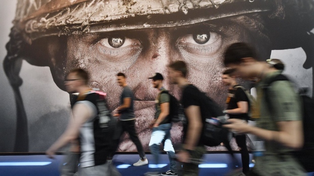 Visitors passing an advertisement for the video game 'Call of Duty' at the Gamescom fair for computer games in Cologne, Germany, Tuesday, Aug. 22, 2017. (AP Photo/Martin Meissner, File)