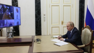 Russian President Vladimir Putin listens to Marina Akhmedova, on the tv screen, while attending the annual meeting of the Presidential Council for Civil Society and Human Rights via videoconference in Moscow, Russia, Wednesday, Dec. 7, 2022. (Mikhail Metzel, Sputnik, Kremlin Pool Photo via AP)