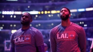 Los Angeles Lakers' LeBron James, left, and Anthony Davis listen to a national anthem before the team's NBA basketball game against the Toronto Raptors on Sunday, Nov. 10, 2019, in Los Angeles. (AP Photo/Marcio Jose Sanchez)
