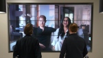 Office workers in London, watch the Duke and Duchess of Sussex's controversial documentary being aired on Netflix Thursday, Dec. 8, 2022. (Jonathan Brady/PA via AP)
