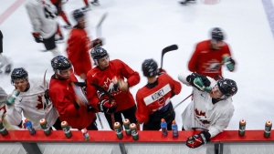 Members of Canada’s National Junior Team take a water break during a training camp practice in Calgary, Tuesday, Aug. 2, 2022. Moved from last December and January to August because of COVID-19, the postponed and reimagined 2022 world junior hockey championship presented unique challenges. THE CANADIAN PRESS/Jeff McIntosh
