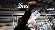 Hundreds of New York Times journalists and other staff protest outside the Times' office after walking off the job for 24 hours, frustrated by contract negotiations that have dragged on for months in the newspaper's biggest labor dispute in more than 40 years, Thursday, Dec. 8, 2022, in New York. (AP Photo/Julia Nikhinson)