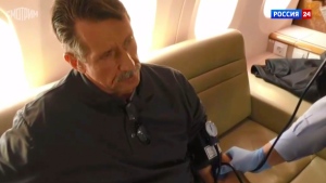 In this image taken from video provided by RU-24 Russian Television on Friday, Dec. 9, 2022, Russian citizen Viktor Bout who was exchanged for U.S. basketball player Brittney Griner, sits in a Russian plane after a swap, in the airport of Abu Dhabi, United Arab Emirates. Russian arms dealer Bout, who was released from U.S. prison in exchange for WNBA star Griner, is widely labeled abroad as the "Merchant of Death" who fueled some of the world's worst conflicts but seen at home as a swashbuckling businessman unjustly imprisoned after an overly aggressive U.S. sting operation. (RU-24 Russian Television via AP)