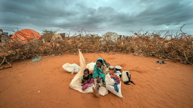 A Somali woman and child wait to be given a spot to settle at a camp for displaced people amid a drought on the outskirts of Dollow, Somalia on Sept. 20, 2022. This past year has seen a horrific flood that submerged one-third of Pakistan, one of the three costliest U.S. hurricanes on record, devastating droughts in Europe and China, a drought-triggered famine in Africa and deadly heat waves all over. (AP Photo/Jerome Delay)