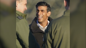 Britain's Prime Minister Rishi Sunak reacts during his visit to RAF Coningsby in Lincolnshire, England, Friday, Dec. 9, 2022, following the announcement that Britain will work to develop next-generation fighter jets with Italy and Japan. (Joe Giddens/Pool Photo via AP)