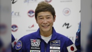 Space flight participant Yusaku Maezawa attends a news conference ahead of the expedition to the International Space Station at the Gagarin Cosmonauts' Training Center in Star City outside Moscow, Russia, on Oct. 14, 2021. Maezawa said Friday, Dec. 9, 2022 that K-pop star TOP will be among the eight crew members who will join him on a flyby around the moon on a SpaceX spaceship next year. (Shamil Zhumatov/Pool Photo via AP, File)