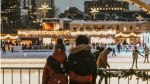 An image of a couple at the skating rink in Nathan Phillips Square in downtown Toronto. (Pexels/Designecologist)