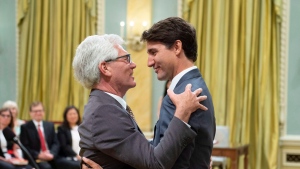 Jim Carr hugs Prime Minister Justin Trudeau