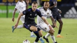 CF Montreal defender Alistair Johnston, left, takes the ball away from LA Galaxy midfielder Victor Vazquez during the second half of an MLS soccer match in Carson, Calif., Monday, July 4, 2022. THE CANADIAN PRESS/AP-Alex Gallardo