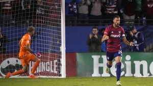 FC Dallas defender Matt Hedges (24) celebrates scoring a goal against Minnesota United goalkeeper Dayne St. Clair (97) in a shootout after overtime play in an MLS soccer playoff match in Frisco, Texas, Monday, Oct. 17, 2022. THE CANADIAN PRESS/AP-LM Otero