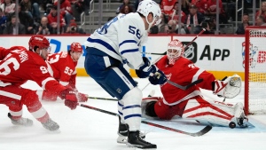 Detroit Red Wings goaltender Ville Husso (35) stops a Toronto Maple Leafs left wing Michael Bunting (58) shot in the third period of an NHL hockey game Thursday, Jan. 12, 2023, in Detroit. (AP Photo/Paul Sancya)