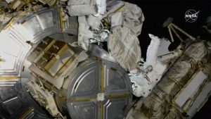 This photo provided by NASA, astronauts NASA's Nicole Mann and Japan's Koichi Wakata venture out on a spacewalk at the International Space Station on Friday, Jan. 20, 2023. Their job was to install support struts for small solar panels launching this summer, part of a continuing effort by NASA to expand the space station's power grid. (NASA via AP)