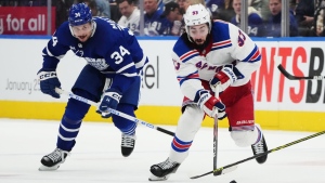 Toronto Maple Leafs forward Auston Matthews (34) chases New York Rangers forward Mika Zibanejad (93) during third period NHL hockey action in Toronto on Wednesday, January 25, 2023. Matthews will miss at least three weeks with a knee sprain, the team announced Friday. THE CANADIAN PRESS/Nathan Denette