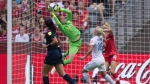 Canada keeper Erin McLeod makes a save in front of England's Katie Chapman (16) during second half FIFA Women's World Cup quarterfinal soccer action in Vancouver, B.C., on Saturday June 27, 2015. THE CANADIAN PRESS/Darryl Dyck