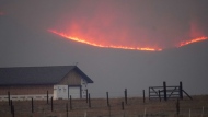 File—Flames rise from mountain ridges as a wildfire burns near a farmstead late Thursday, Oct. 22, 2020, near Granby, Colo. A bill is being introduced in the Colorado Legislature to create a $2-million pilot program to use cameras likely equipped with artificial intelligence technology in high-risk areas to help identify fires before they can burn out of control. (AP Photo/David Zalubowski, File)
David Zalubowski