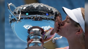 Diede de Groot of the Netherlands kisses her trophy after defeating Yui Kamiji of Japan in the women's wheelchair final at the Australian Open tennis championship in Melbourne, Australia, Saturday, Jan. 28, 2023. (AP Photo/Ng Han Guan)