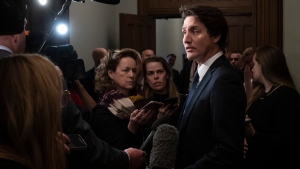 Prime Minister Justin Trudeau speaks with media before attending caucus on Parliament Hill, Friday, January 27, 2023 in Ottawa. THE CANADIAN PRESS/Adrian Wyld