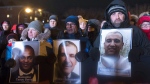 People hold pictures of the victims at a vigil to commemorate the one-year anniversary of the Quebec City mosque shooting, in Quebec City, Monday, Jan. 29, 2018. A ceremony will be held this evening to mark the sixth anniversary of Quebec City's deadly mosque shooting. THE CANADIAN PRESS/Jacques Boissinot
