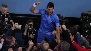 Novak Djokovic of Serbia celebrates after defeating Stefanos Tsitsipas of Greece in the men's singles final at the Australian Open tennis championships in Melbourne, Australia, Sunday, Jan. 29, 2023. (AP Photo/Ng Han Guan)