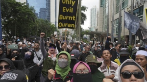 Muslim protesters shout slogans during a rally outside the Swedish Embassy in Jakarta, Indonesia, Monday, Jan. 30, 2023. Hundreds of Indonesian Muslims marched to the heavily guarded Swedish Embassy in the country's capital on Monday to denounce the recent desecration of Islam's holy book by far-right activists in Sweden and the Netherlands. (AP Photo/Tatan Syuflana)