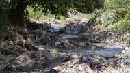 A tributary of the Nairobi River, which traverses informal settlements and industrial hubs, is seen full of garbage in Nairobi, Kenya, Wednesday, Jan. 11, 2023. As clean water runs short, one of Africa's fastest growing cities is struggling to balance the needs of creating jobs and protecting the environment, and the population of over 4 million feels the strain. (AP Photo/Khalil Senosi)