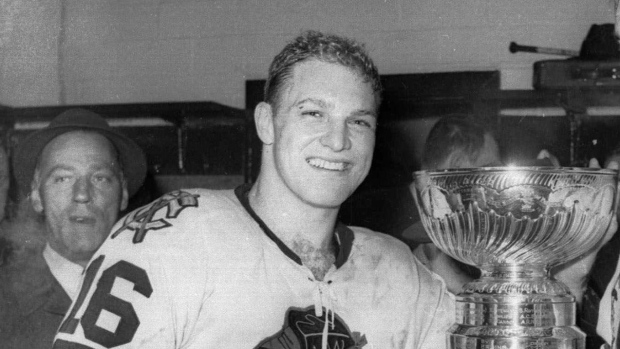 In this April 16, 1961, file photo, Chicago Blackhawks hockey player Bobby Hull smiles in the dressing room beside the Stanley Cup after Chicago defeated the Detroit Red Wings, 5-1, to win the NHL Championship, in Detroit. THE CANADIAN PRESS/AP