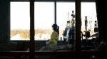 A registered nurse takes a moment to look outside while attending to a patient in the intensive care unit at the Humber River Hospital in Toronto on Tuesday, January 25, 2022. The Ontario Nurses' Association has started bargaining a new contract today for hospital nurses and the union plans a series of actions to bolster its push for higher wages.THE CANADIAN PRESS/Nathan Denette