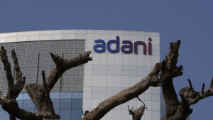 FILE- Dried branches of a tree stand outside Adani Corporate House in Ahmedabad, India, Friday, Jan. 27, 2023. The closely watched $2.5 billion share sale launched by Asia’s richest man, Gautam Adani, was fully subscribed on Tuesday. The share sale and its success were seen as a crucial test of investor confidence in Adani, whose sprawling empire shed tens of billions of dollars within a week after Hindenburg Research accused the conglomerate of stock market manipulation and fraud. (AP Photo/Ajit Solanki, File)