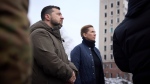In this photo provided by the Ukrainian Presidential Press Office, Danish Prime Minister Mette Frederiksen, center, and Ukrainian President Volodymyr Zelenskyy look at the site of the recent Russian shelling in Mykolaiv, Ukraine, Monday, Jan. 30, 2023. (Ukrainian Presidential Press Office via AP)