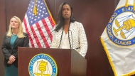 Cook County, Ill., State's Attorney Kim Foxx, center, announced Monday, Jan. 30, 2023, in Chicago that she is dropping sex abuse charges against singer R. Kelly. Kelly, born Robert Sylvester Kelly, is serving a 30-year prison sentence in the New York case and awaits sentencing on Feb. 23, in Chicago federal court. (AP Photo/Claire Savage)