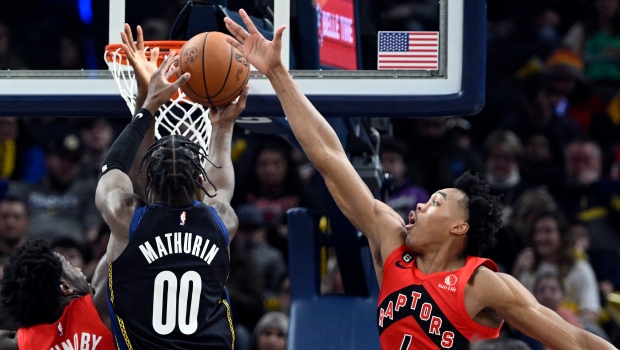 Toronto Raptors forward Scottie Barnes (4) attempts to block a shot by Indiana Pacers guard Bennedict Mathurin (00) during the second quarter of an NBA basketball game, Saturday, Nov. 12, 2022, in Indianapolis, Ind. (AP Photo/Marc Lebryk)