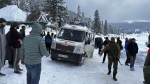An ambulance leaves carrying the bodies of two foreigners who were killed in an avalanche in Gulmarg, 55 kilometers (34 miles) from Srinagar, in Indian controlled Kashmir, Wednesday, Feb 1, 2023. An avalanche at a Himalayan ski resort in Indian-controlled Kashmir Wednesday killed two foreign skiers while 21 others were rescued, police said. (AP Photo/Umar Mehraj)