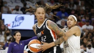Phoenix Mercury center Brittney Griner (42) drives past Chicago Sky forward Candace Parker (3) during the first half of Game 1 of the WNBA basketball Finals, Sunday, Oct. 10, 2021, in Phoenix. Brittney Griner's return to the WNBA this summer after being traded in a dramatic prisoner swap in December with Russia has collided with free agency, creating potential travel complications for the league out of safety concerns for her.( AP Photo/Ralph Freso, File)