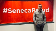 Actor Ryan Reynolds poses in front of a sign at Toronto's Seneca College. (Twitter/@VancityReynolds)