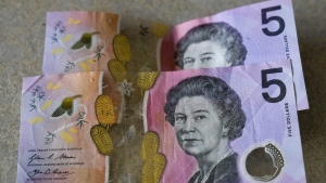 FILE - Australian $5 notes are pictured in Sydney on Sept. 10, 2022. King Charles III won’t feature on Australia's new $5 bill, the nation's central bank announced Thursday, Feb. 2, 2023, signaling a phasing out of the British monarchy from Australian bank notes, although he is still expected to feature on coins. (AP Photo/Mark Baker, File)