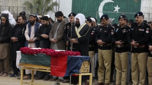 Police officials and others attend the funeral prayer of a police officer, a victim of Monday's suicide bombing, in Peshawar, Pakistan, Feb. 2, 2023. (AP Photo/Muhammad Sajjad)