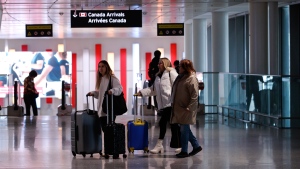 Travellers make their way through Pearson International Airport in Toronto Monday, Nov. 14, 2022. THE CANADIAN PRESS/Cole Burston