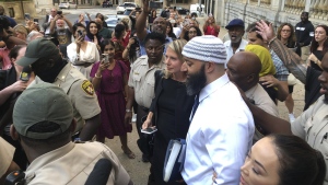 Adnan Syed, center, leaves the Cummings Courthouse on Sept. 19, 2022, in Baltimore. The protracted legal odyssey of Syed, whose murder case rose to prominence through the hit podcast “Serial,” marked its latest development Thursday, Feb. 2, 2023, when a Maryland appeals court heard arguments about whether the victim’s family experienced improper treatment when a Baltimore court overturned Syed’s conviction last year, allowing his release after more than two decades behind bars. (AP Photo/Brian Witte, File)