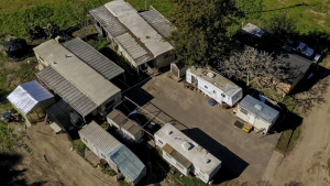 FILE - In this photo taken by a drone, a cluster of mobile homes is seen at the California Terra Garden, formerly Mountain Mushroom Farm in Half Moon Bay, Calif., Thursday, Jan. 26, 2023. Workers who witnessed the Jan. 23, 2023, shooting or worked at one of the farms spoke to The Associated Press on Feb. 2, 2023, about what they saw and their working conditions. Authorities say Chunli Zhao shot and killed seven people and injured an eighth at two mushroom farms where he had worked. (Santiago Mejia/San Francisco Chronicle via AP, File)