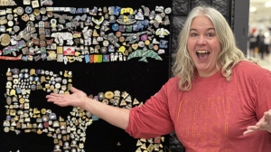 Janet Pacey from Yellowknife poses with some of the Arctic Winter Games pins that she has collected over the years in this Friday, February 3, 2023 handout photo. New and seasoned pin traders, affectionately known as "pinheads" can often be found at the biennial sporting event swapping pins from across the circumpolar north or on the hunt for rare ones to add to their trove. THE CANADIAN PRESS/HO, Janet Pacey